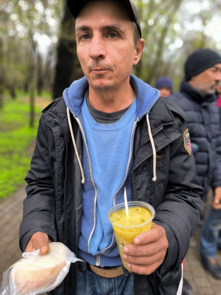 Ukraine outreach-man receives sandwich and soup.