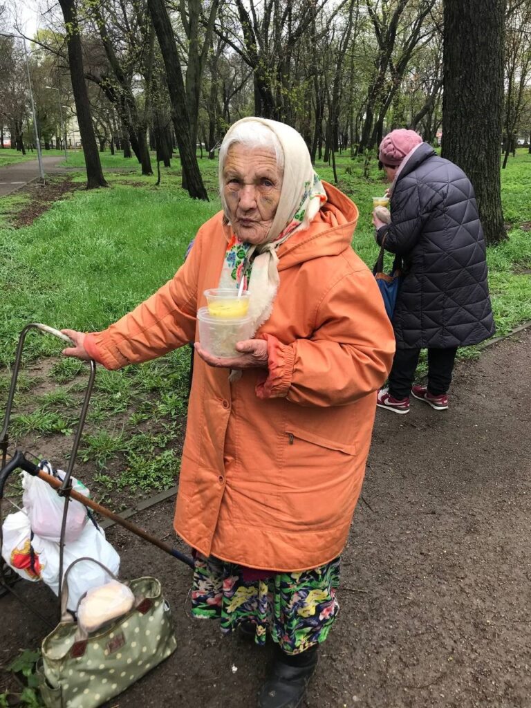 Ukraine outreach-two elderly women receive food.