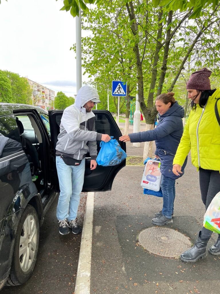 man providing essentials to women in Ukraine