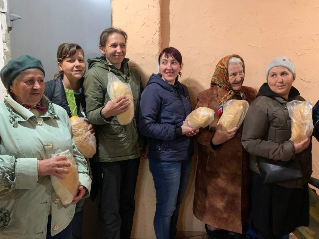 women receive bread in Ukraine