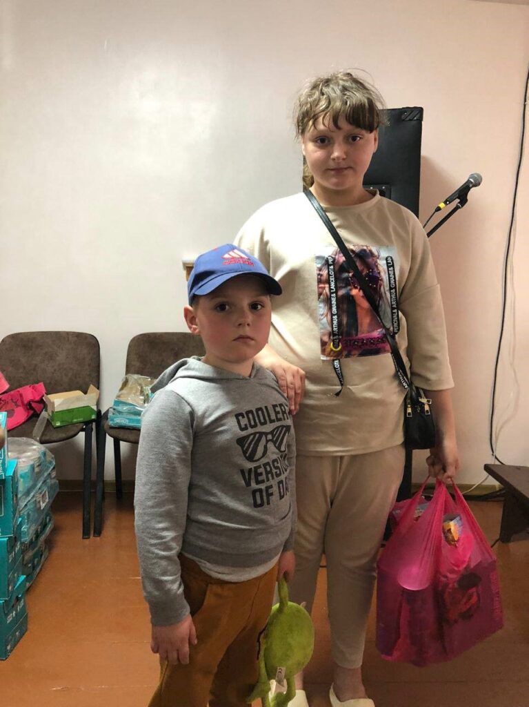 Girl & Boy receive supplies in Odessa.