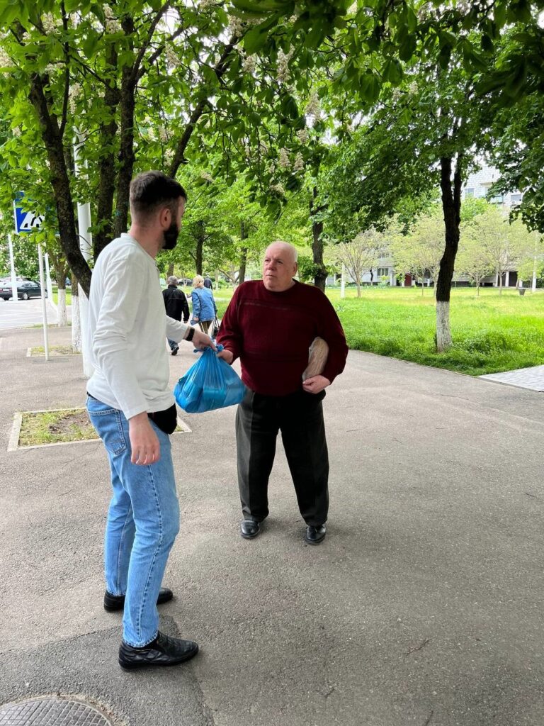 Man giving supplies to another man.