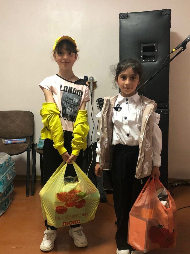 Two girls receive supplies in Odessa.