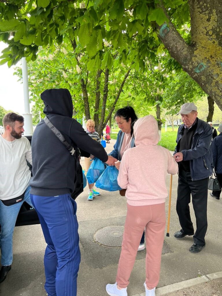 Various people giving and receiving supplies.