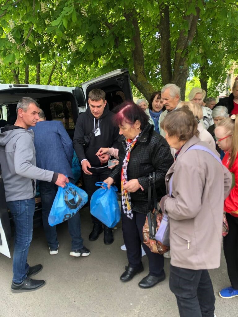 Man distributing supplies from a truck.