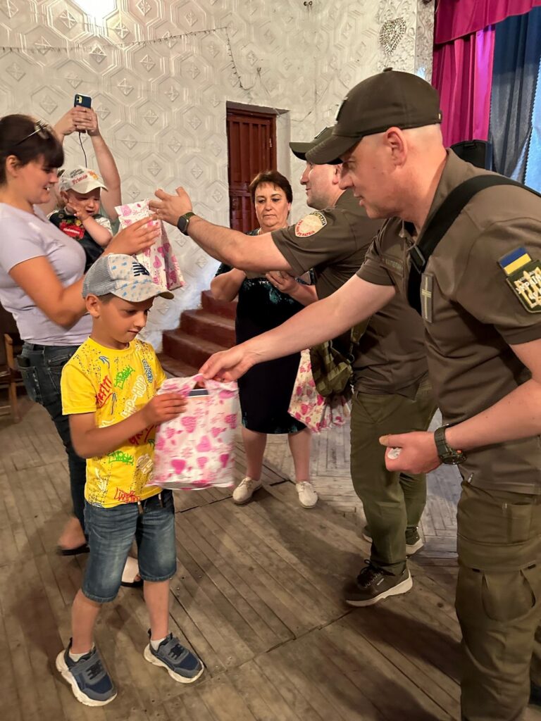 Boy receiving giftbag in an outreach.