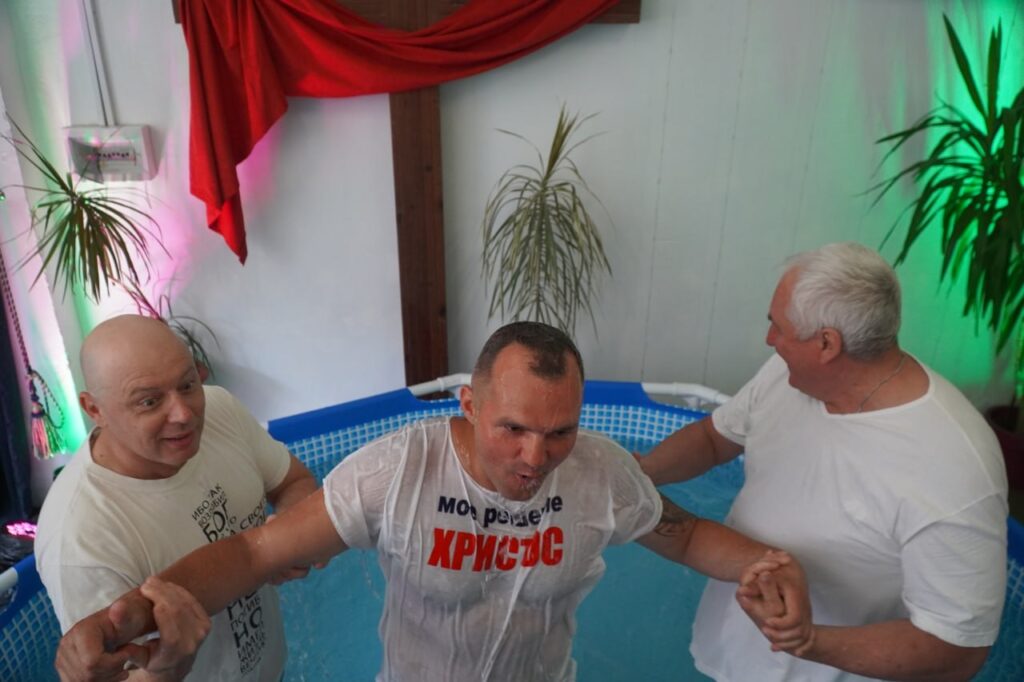 Man coming out of the water after being water baptized.