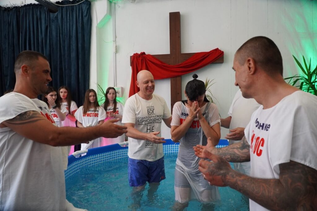 Woman coming out of the water after being baptized.