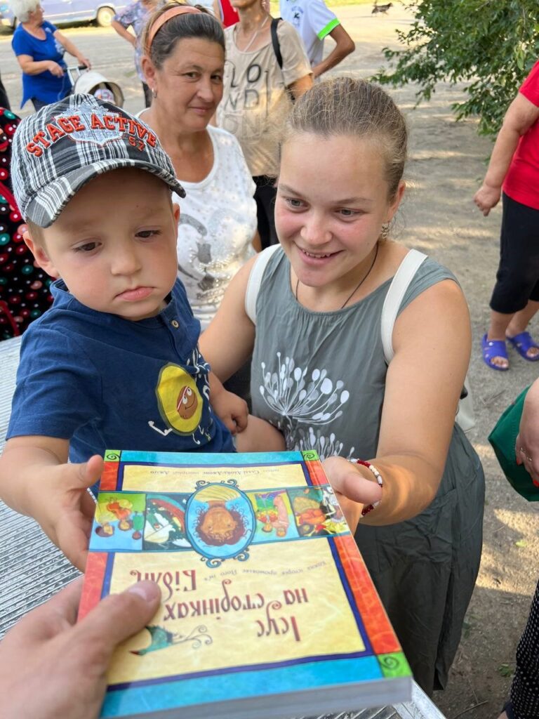Toddler receives children's Bible.
