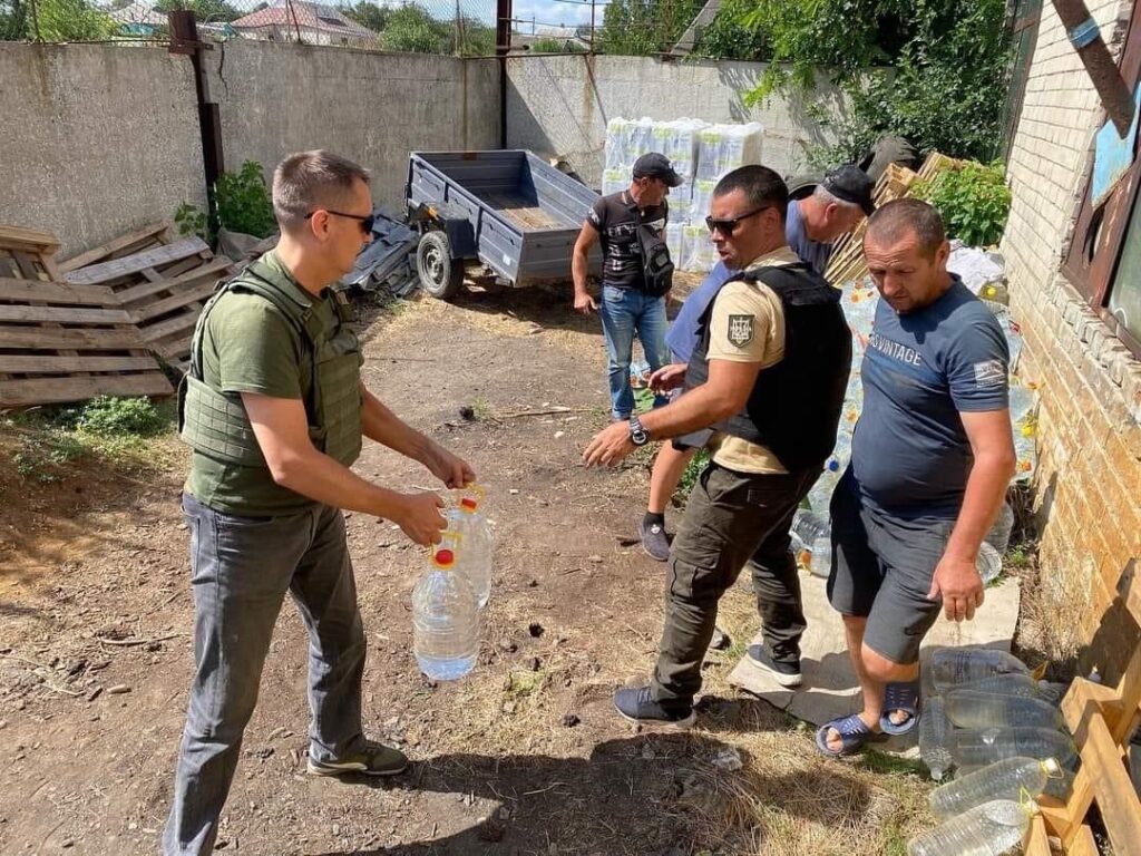 Men giving water to others in the area.