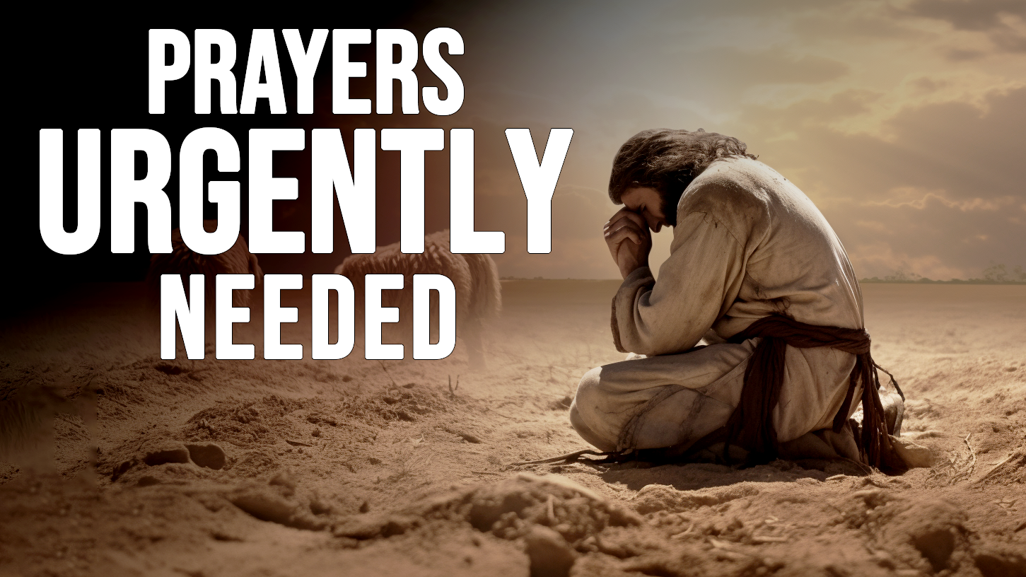 Man praying on desert ground