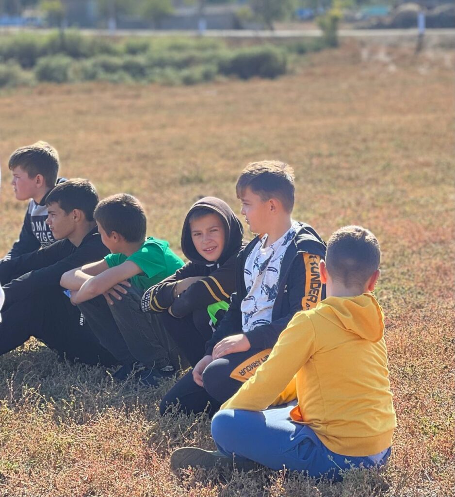 Boys sitting on the grass