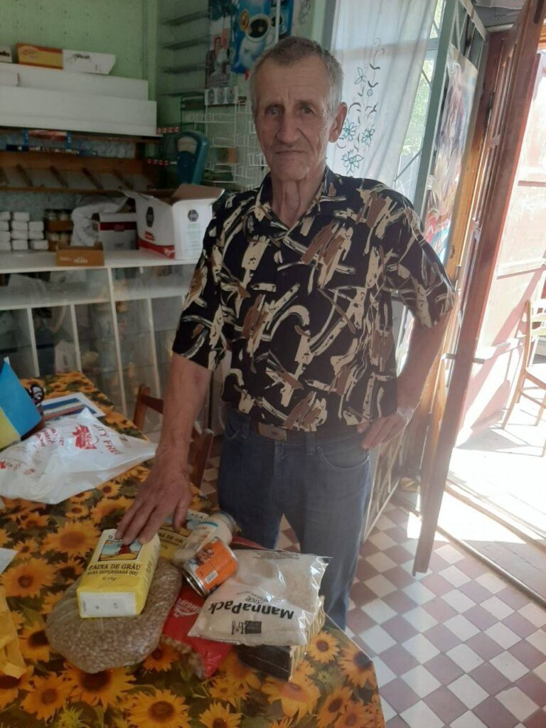 Man receiving food products near a table