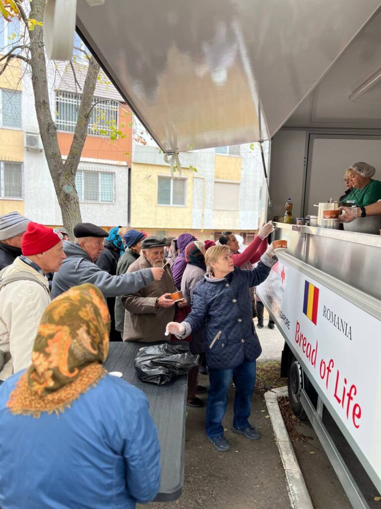 Group of people receiving food from food truck