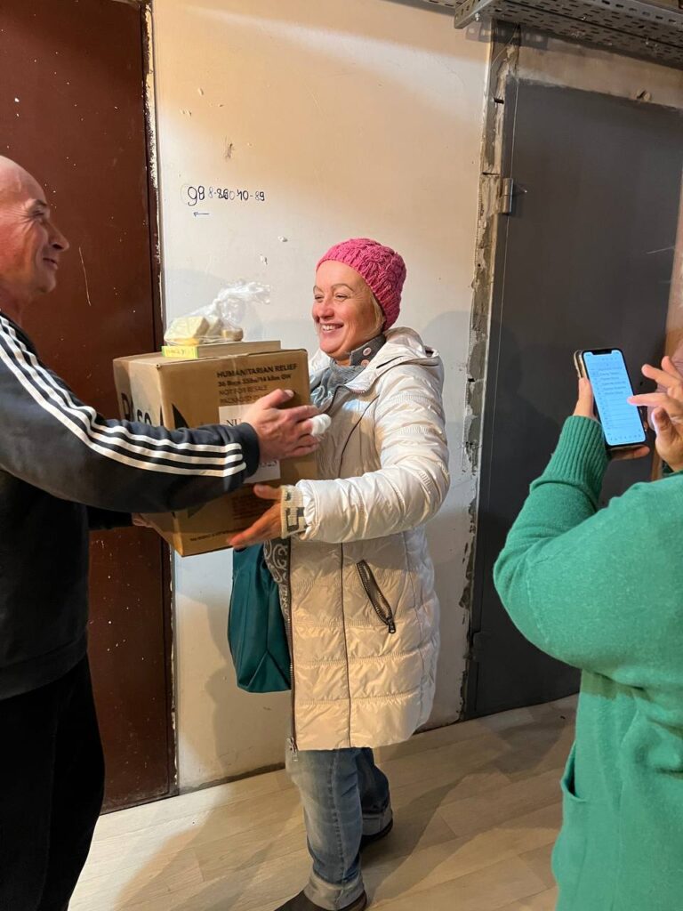 Man and woman exchanging box from outreach
