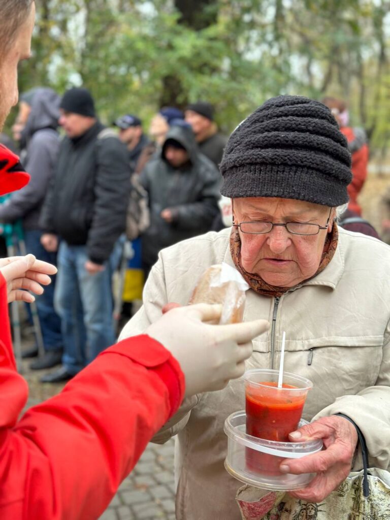 Older woman being handed free meal