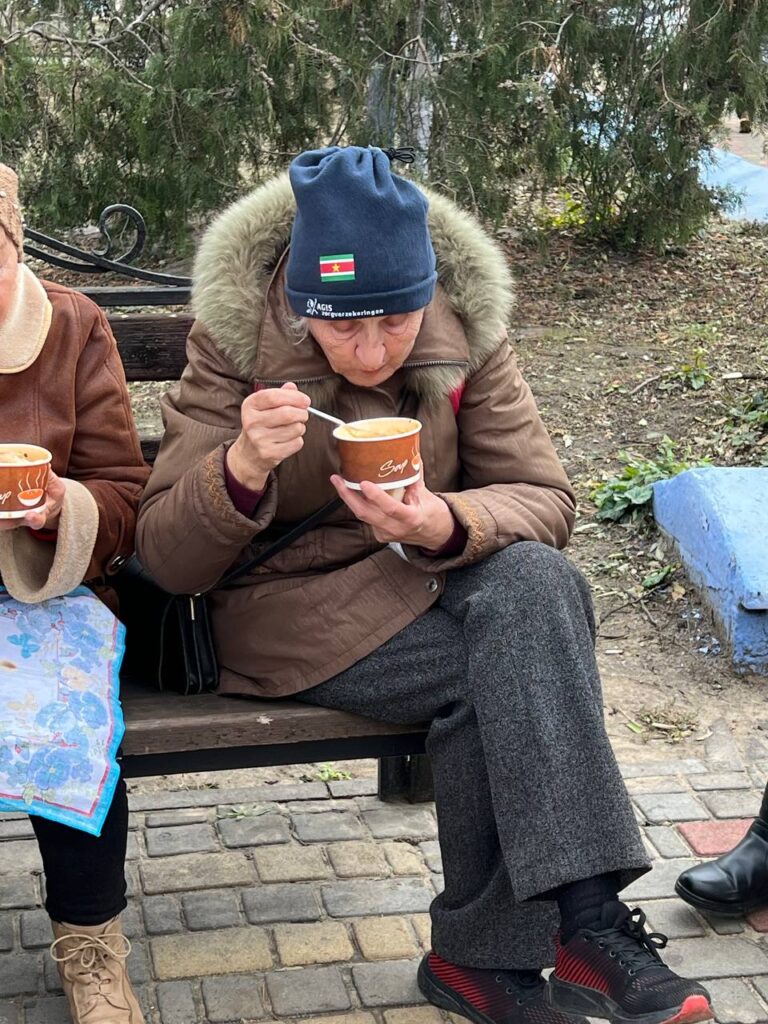 Photo of elderly woman eating soup