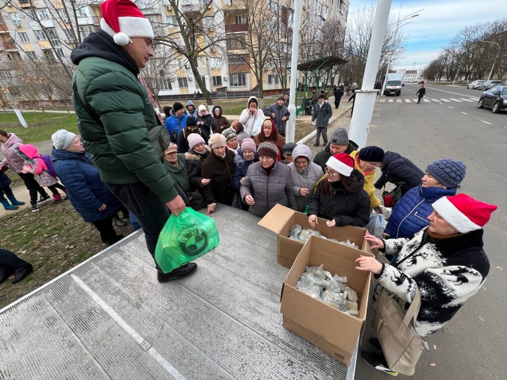 Man handing out gifts to group of people
