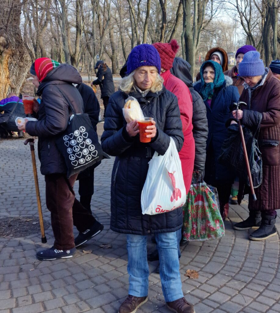 Woman holding food during outreach