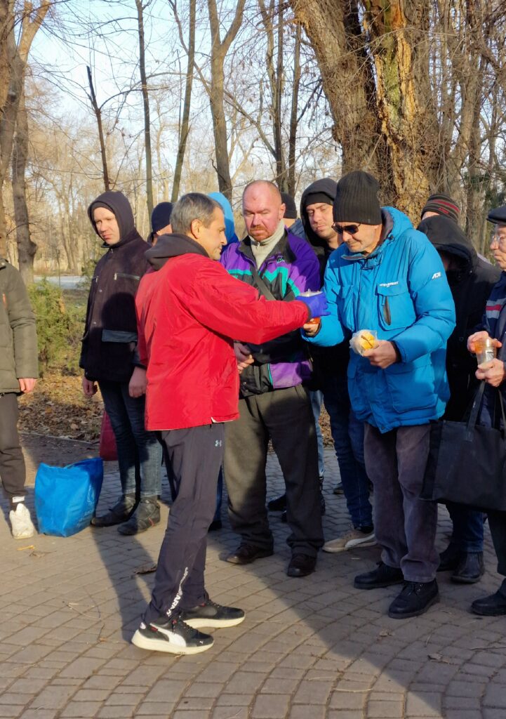 Man serving food to group of people