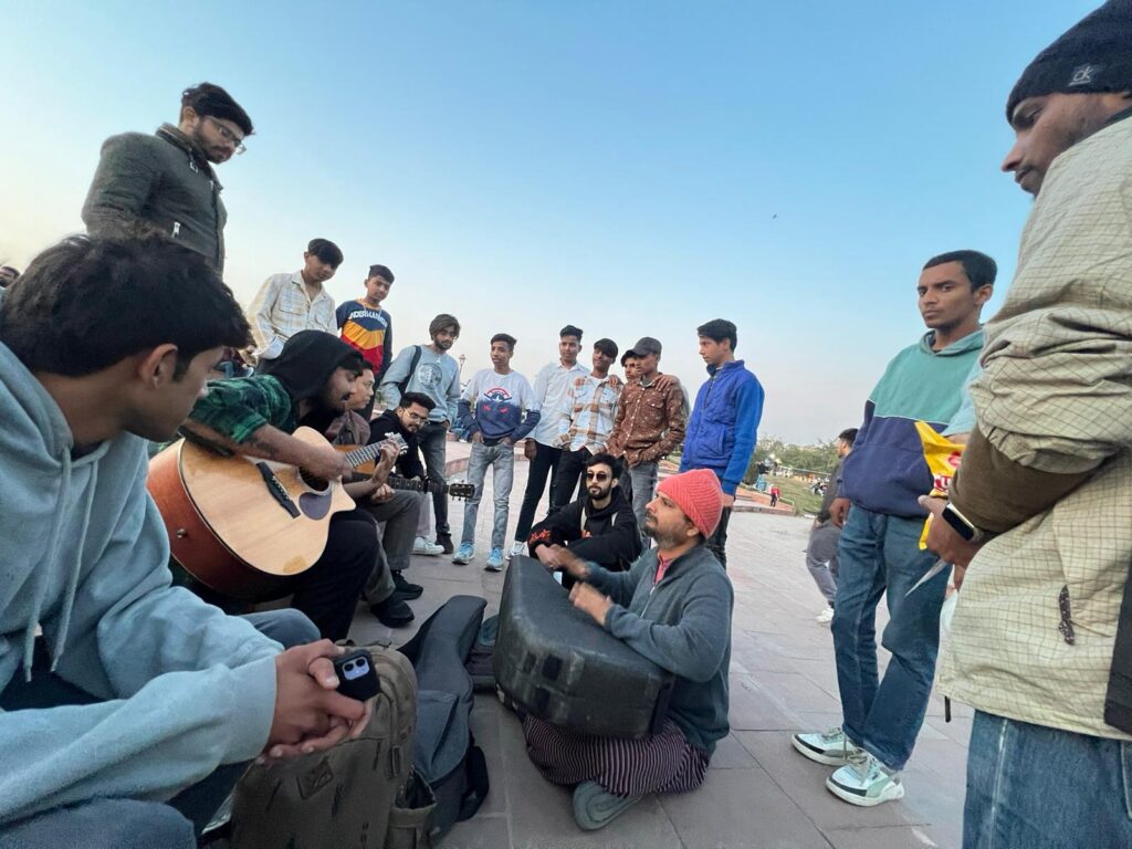 Photos of men gathered together outside during outreach in India