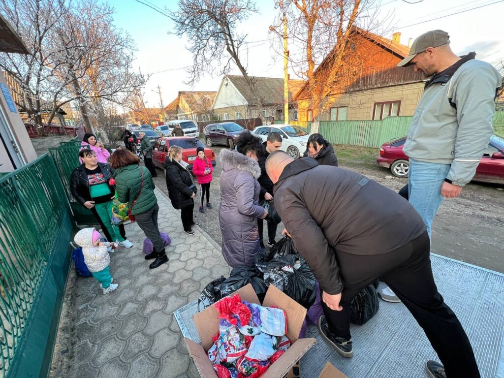 Refugees receiving donations of food during outreach