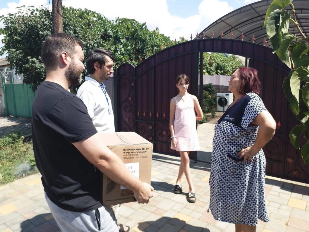 Four people standing around looking at each other.